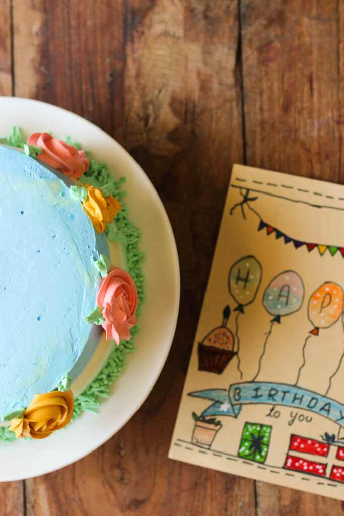 Eggless mango cake decorated with edible flowers