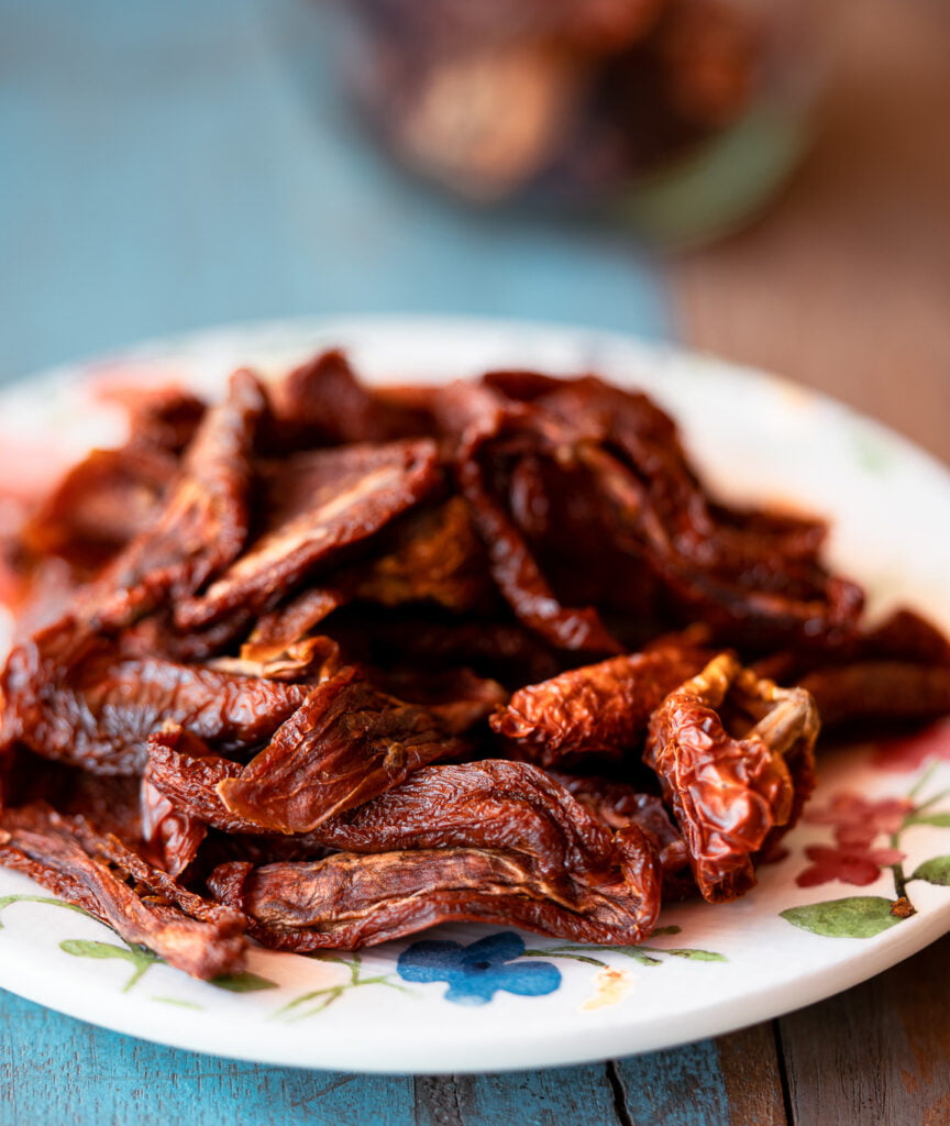 Sun-dried tomatoes with wrinkled texture on a wooden surface