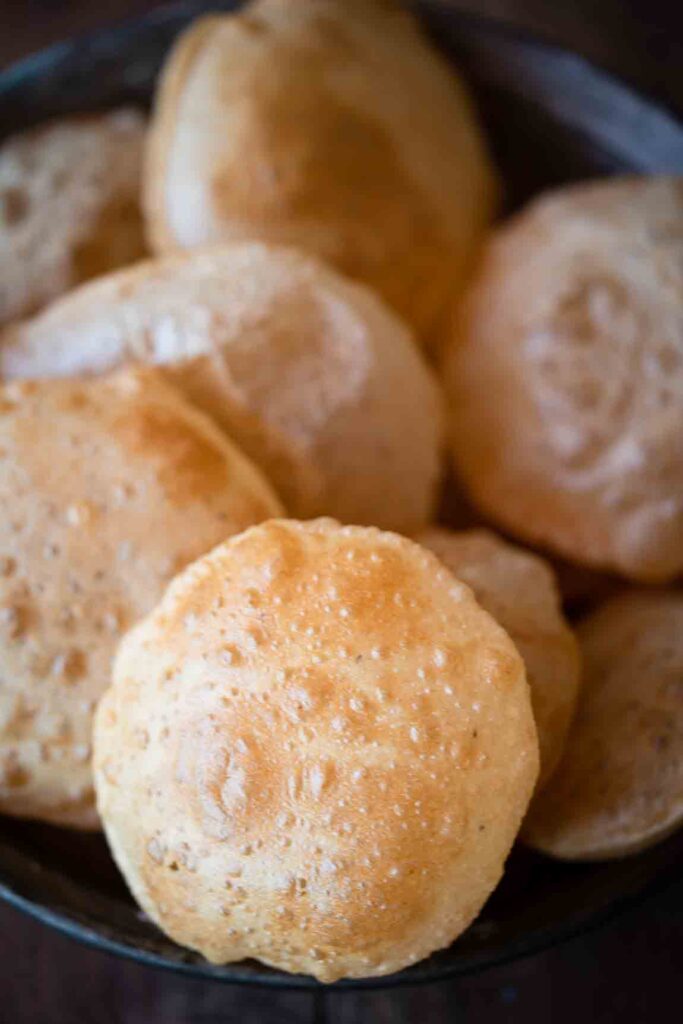 Soft puffy poori fried to golden perfection