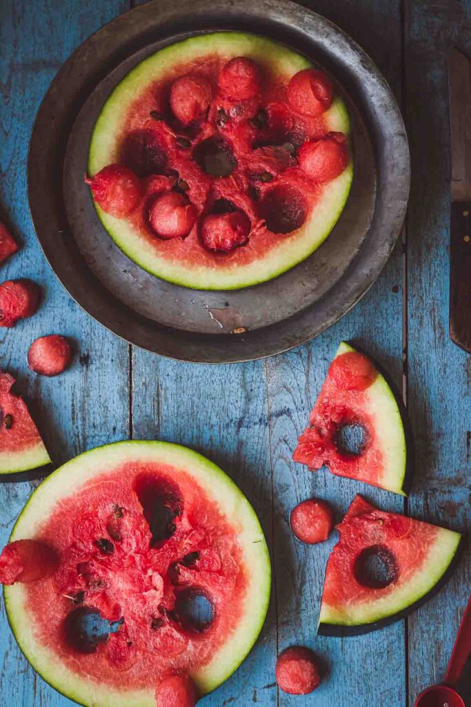 Watermelon kept on the wooden table and plate